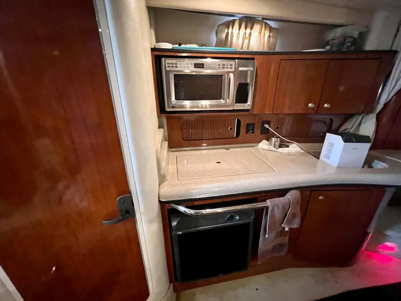Slide: The Image of 2007 Sea Ray 320 Sundancer repowered galley with microwave and oven. - 23