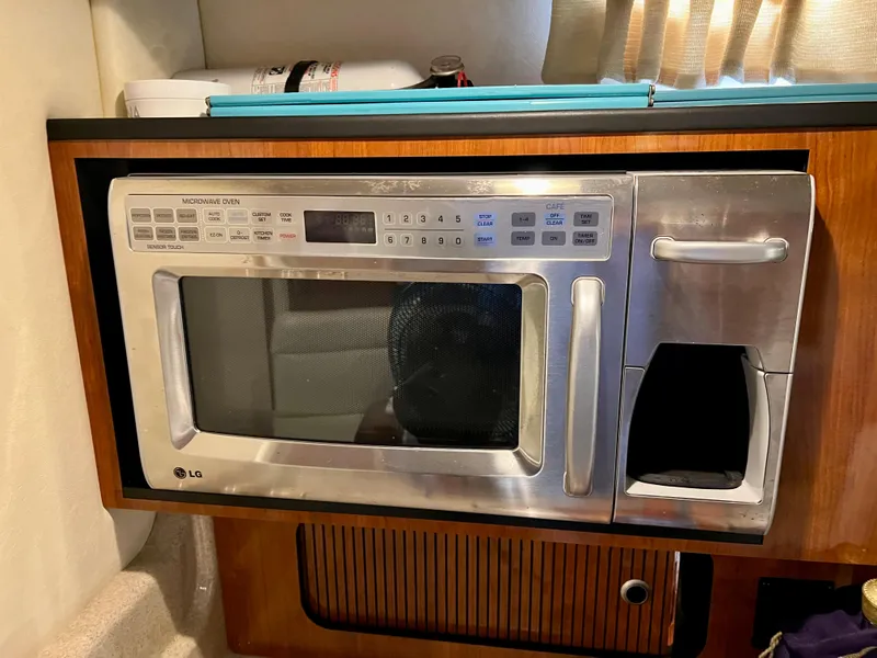 Slide: The Image of Built-in LG microwave in 2007 Sea Ray 320 Sundancer repowered boat galley. - 25