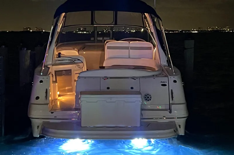 Slide: The Image of 2007 Sea Ray 320 Sundancer repowered yacht with illuminated deck at night. - 28