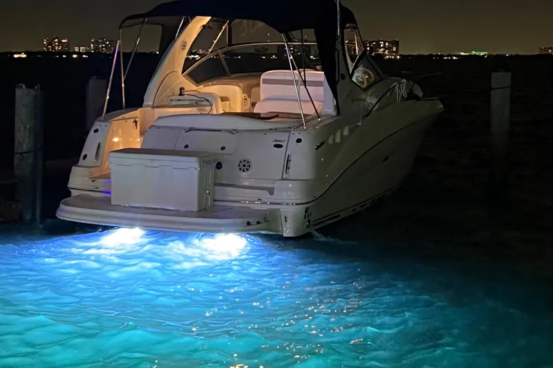 Slide: The Image of 2007 Sea Ray 320 Sundancer repowered, illuminated at night on the water. - 29