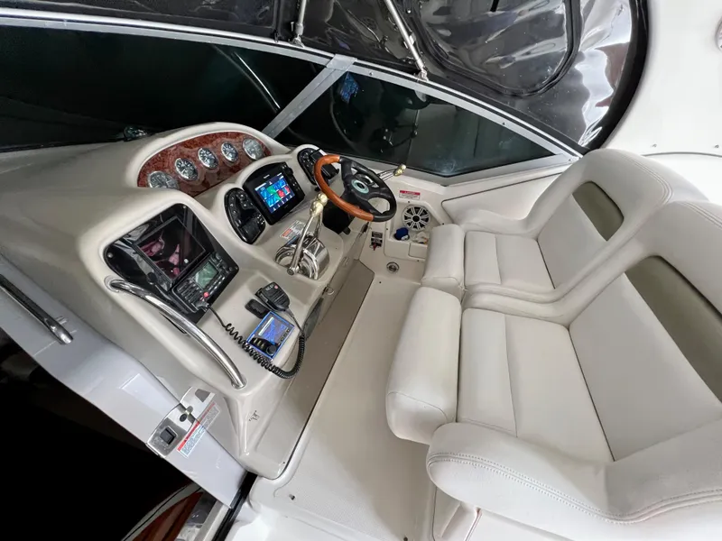 Slide: The Image of 2007 Sea Ray 320 Sundancer repowered helm with modern navigation equipment and dual seating. - 9