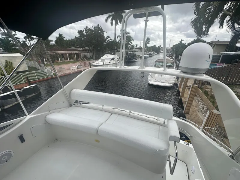 Slide: The Image of 2005 Carver 36 Super Sport yacht docked in a residential canal. - 15