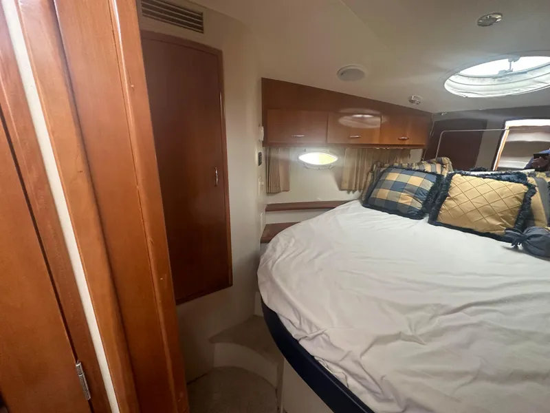 Slide: The Image of Interior cabin of 2005 Carver 36 Super Sport yacht with bed and wooden cabinets. - 16