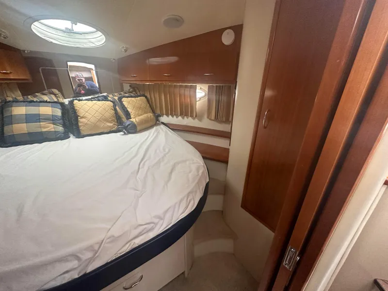 Slide: The Image of Interior cabin of a 2005 Carver 36 Super Sport yacht with bed and storage. - 24