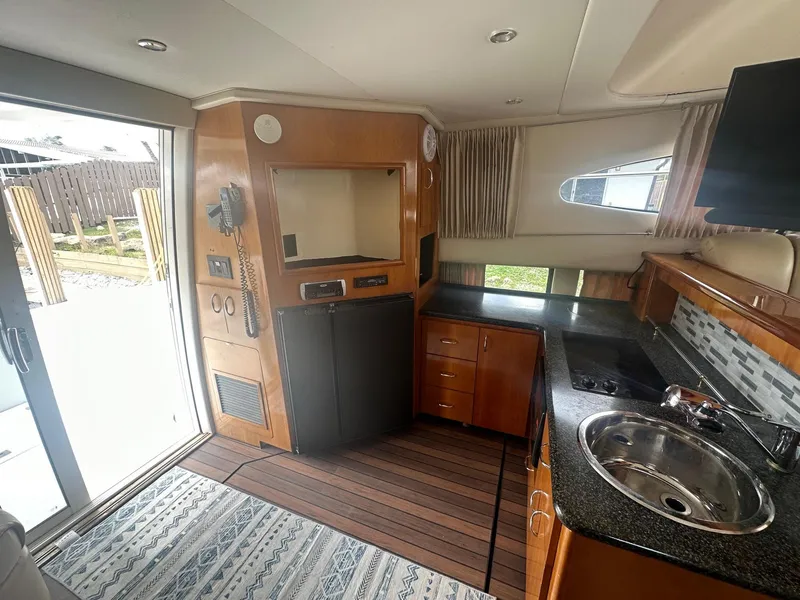 Slide: The Image of Interior of 2005 Carver 36 Super Sport yacht with kitchenette and sliding door. - 29