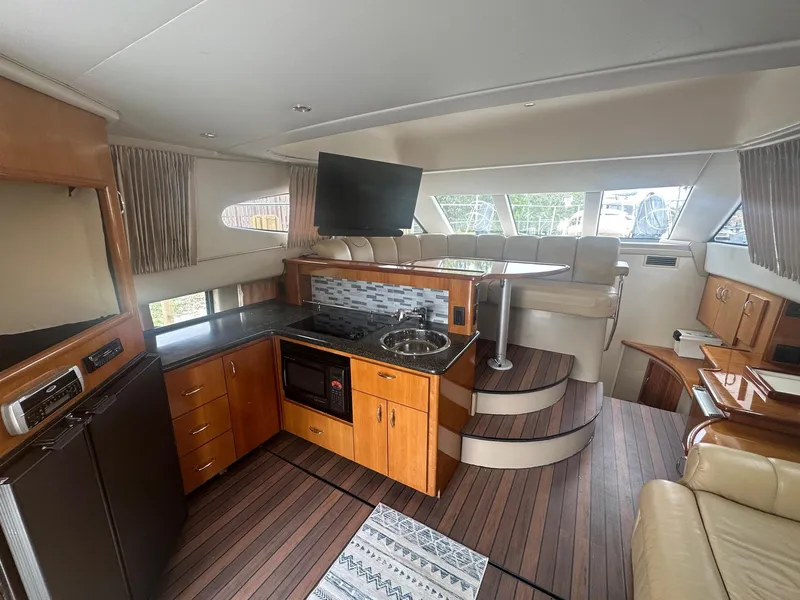 Slide: The Image of Interior of 2005 Carver 36 Super Sport yacht with modern kitchen and seating area. - 30