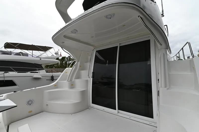Slide: The Image of 2005 Carver 36 Super Sport yacht with spacious deck and sliding glass doors. - 32