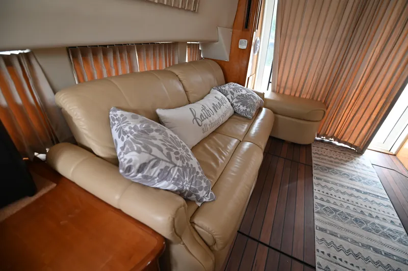 Slide: The Image of Luxurious interior of 2005 Carver 36 Super Sport with beige leather sofa and decorative pillows. - 38