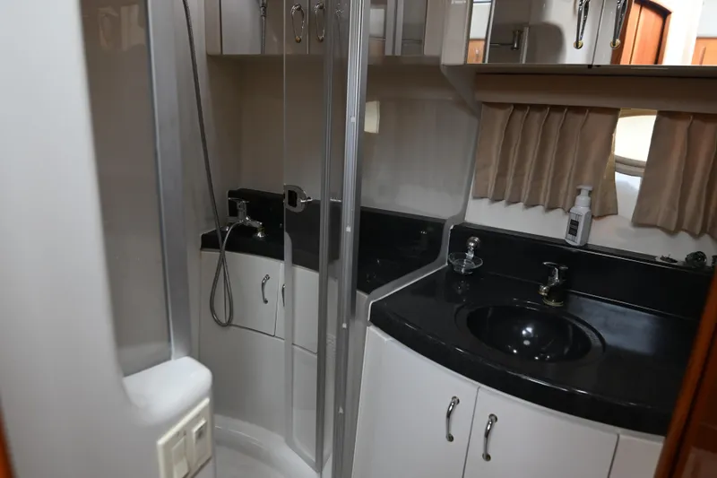 Slide: The Image of 2005 Carver 36 Super Sport bathroom with shower, black countertop, and sink. - 41
