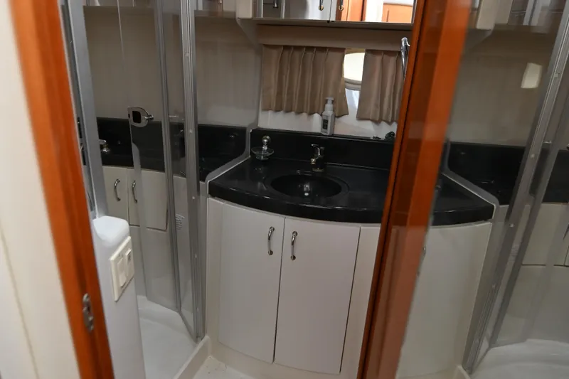 Slide: The Image of 2005 Carver 36 Super Sport yacht bathroom with black countertop and sink. - 42
