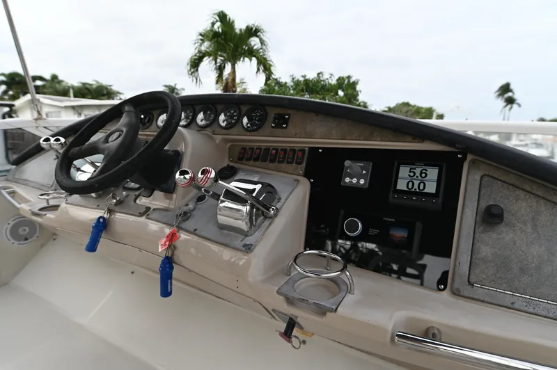 Slide: The Image of 2005 Carver 36 Super Sport boat helm with steering wheel and control panel. - 7