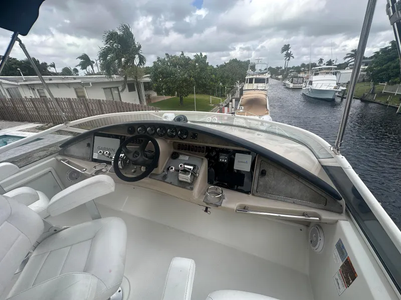Slide: The Image of Cockpit view of a 2005 Carver 36 Super Sport yacht docked at a marina. - 12