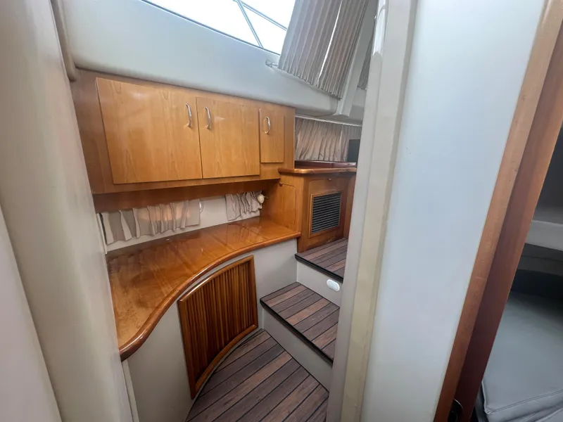 Slide: The Image of Interior of 2005 Carver 36 Super Sport yacht with wooden cabinets and steps. - 17