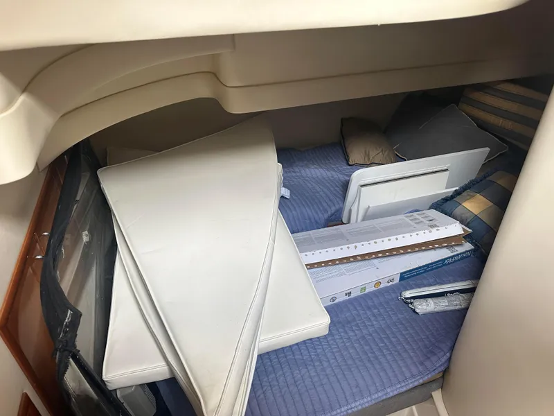 Slide: The Image of Interior cabin of a 2005 Carver 36 Super Sport with cushions and bedding. - 22