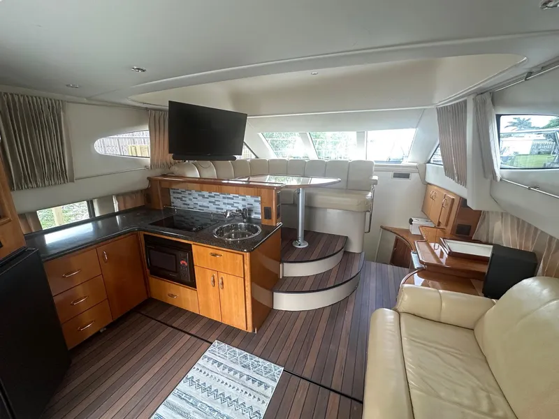 Slide: The Image of Interior of 2005 Carver 36 Super Sport yacht with modern kitchen and seating area. - 25