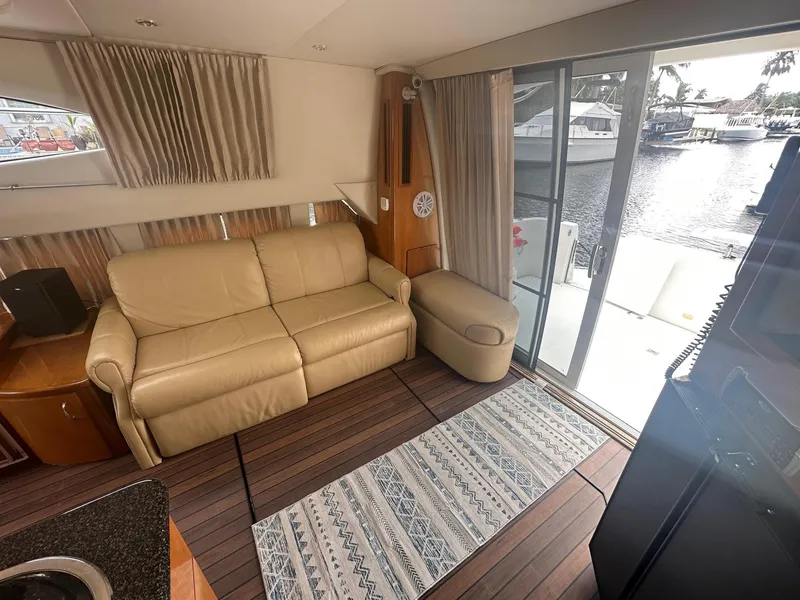 Slide: The Image of Interior of 2005 Carver 36 Super Sport yacht with leather sofa and waterfront view. - 27