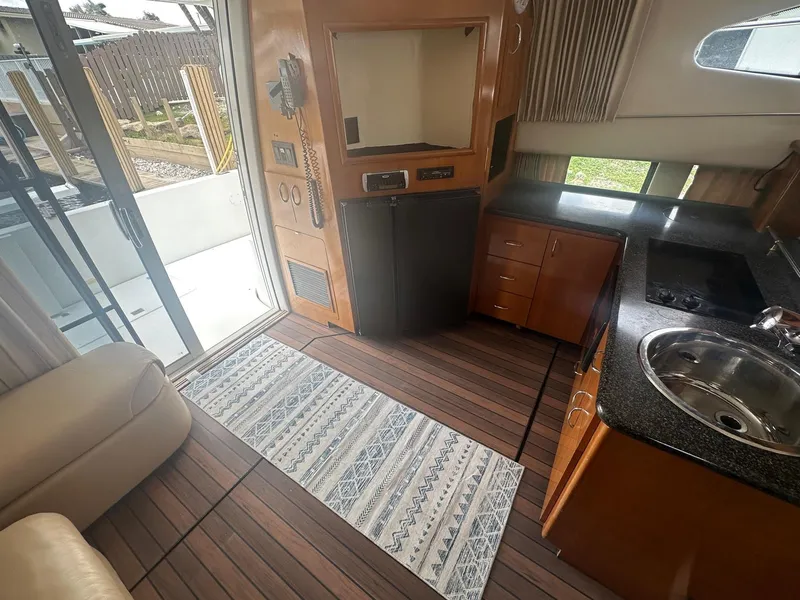 Slide: The Image of Interior of 2005 Carver 36 Super Sport yacht with kitchenette and sliding door. - 28