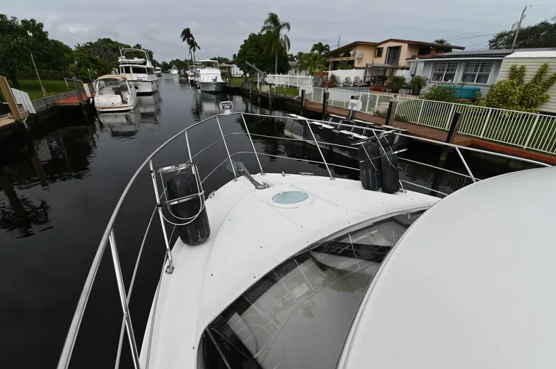 Slide: The Image of 2005 Carver 36 Super Sport yacht docked in a residential canal. - 4