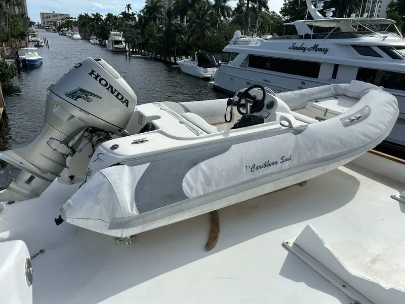 Slide: The Image of Inflatable boat with Honda motor on 1983 Broward 103 Raised Pilot House yacht. - 26