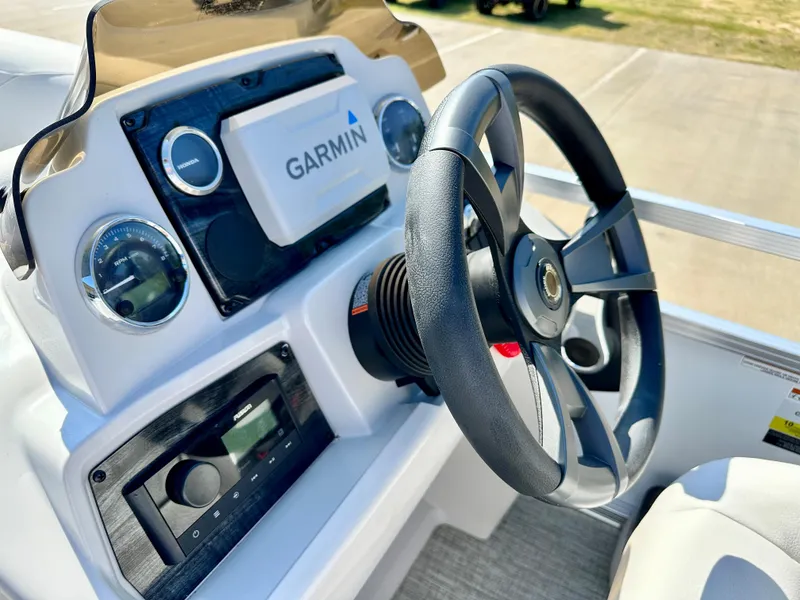 Slide: The Image of 2023 Tahoe Pontoon 19FT STX Cruise dashboard with Garmin navigation system and steering wheel. - 6