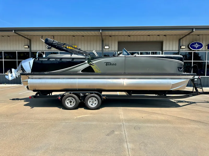 Slide: The Image of 2023 Tahoe Pontoon LTZ Cruise 23FT on trailer outside dealership. - 1