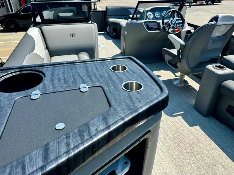 Slide: The Image of 2023 Tahoe Pontoon LTZ Cruise 23FT interior with seating and control console. - 5