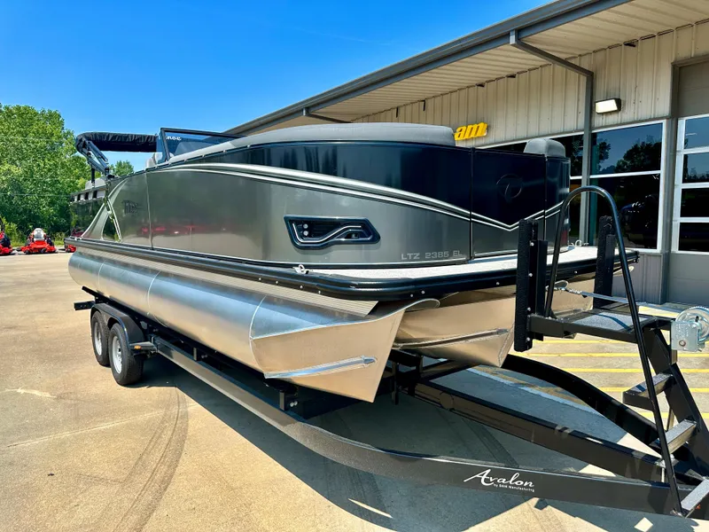Slide: The Image of 2023 Tahoe Pontoon LTZ Cruise 23FT on trailer outside dealership. - 8