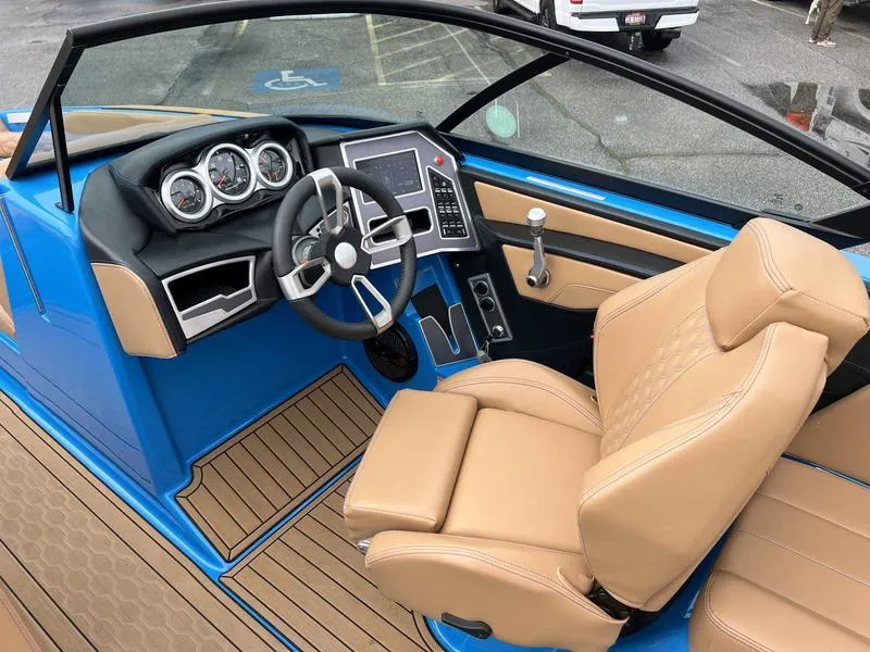 Slide: The Image of 2023 MasterCraft XT23 boat interior with tan seats and modern dashboard. - 3