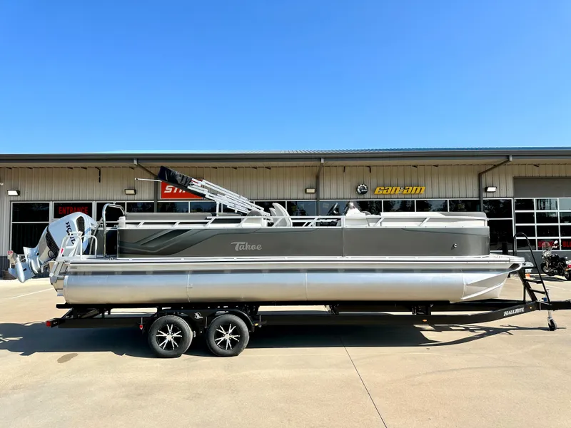 Slide: The Image of 2023 Tahoe Pontoon 25 FT LTZ Quad Lounger on trailer, parked outside dealership. - 0