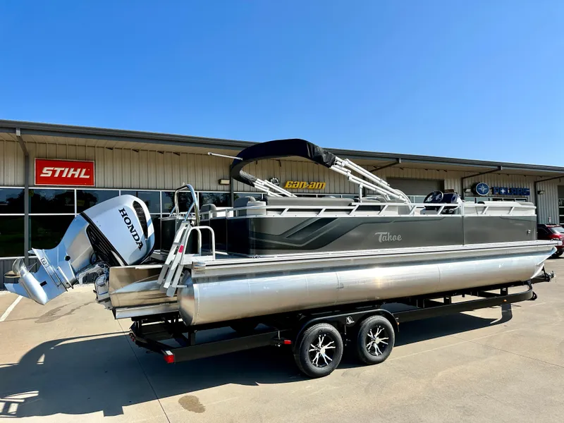 Slide: The Image of 2023 Tahoe Pontoon 25 FT LTZ Quad Lounger with Honda engine on trailer. - 1