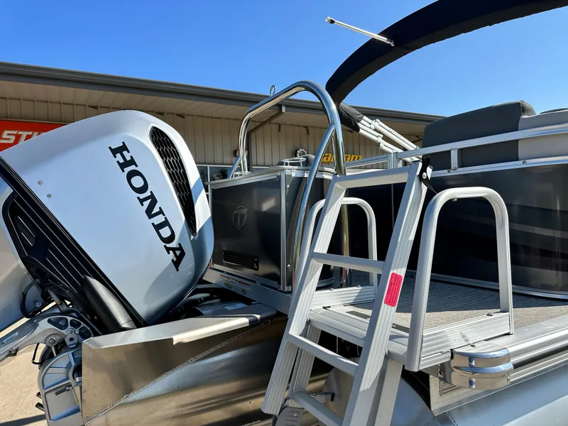 Slide: The Image of 2023 Tahoe Pontoon 25 FT LTZ Quad Lounger with Honda outboard motor and boarding ladder. - 10