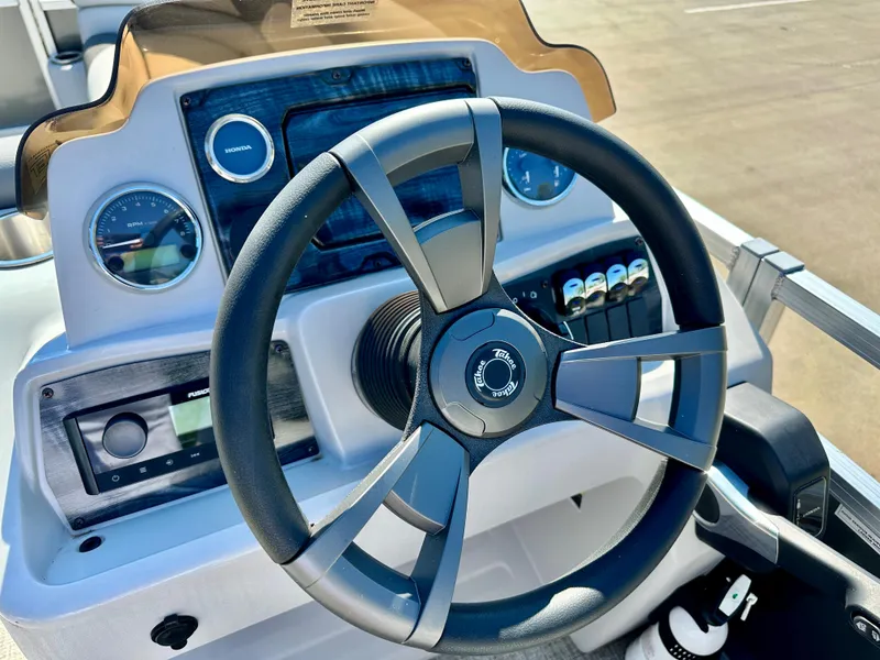 Slide: The Image of 2023 Tahoe Pontoon 25 FT LTZ Quad Lounger steering wheel and dashboard. - 5