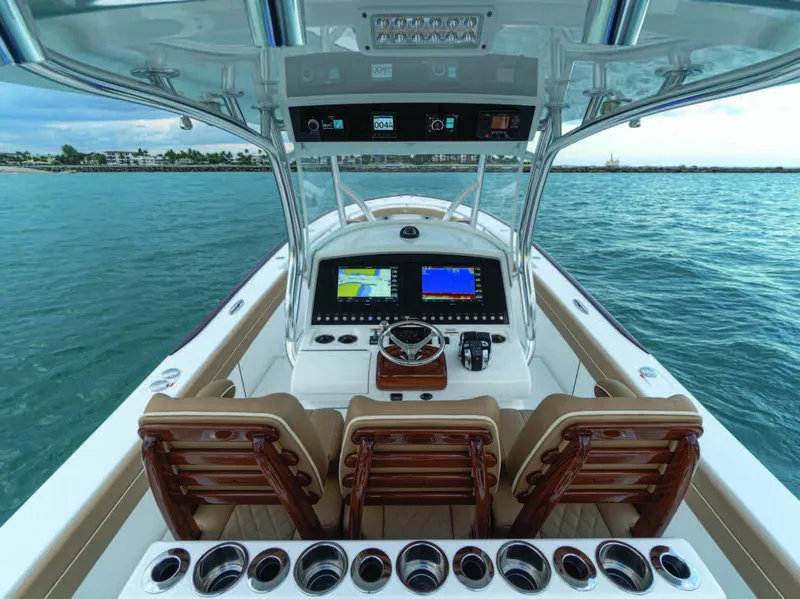 Slide: The Image of 2025 Valhalla Boatworks V-37 helm with advanced navigation systems and luxurious seating on open water. - 13