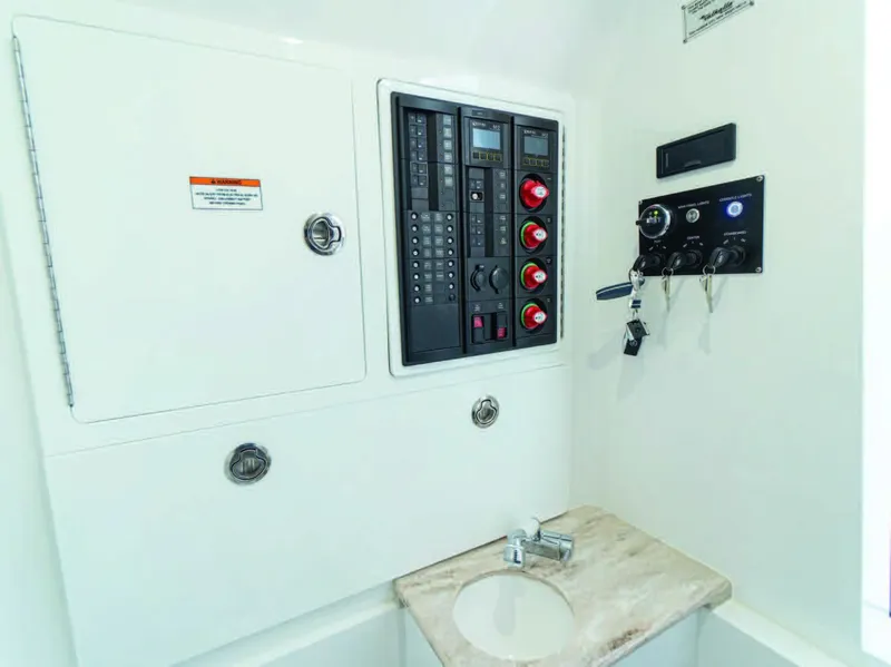 Slide: The Image of Electrical control panel and sink area on 2025 Valhalla Boatworks V-37. - 27