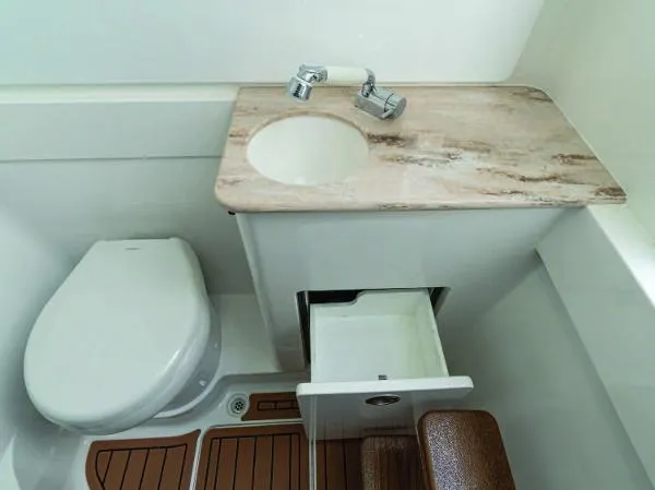 Slide: The Image of 2025 Valhalla Boatworks V-41 bathroom with sink, toilet, and storage drawer. - 28