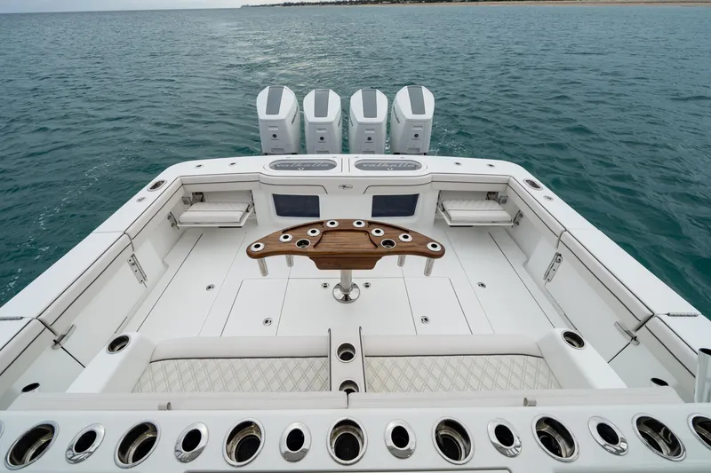 Slide: The Image of 2025 Valhalla Boatworks V-55, spacious deck with quad outboard engines on open water. - 15