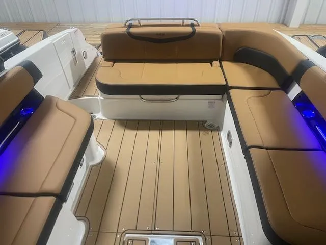 Slide: The Image of 2025 Chaparral 307 SSX boat interior with tan seating and wood flooring. - 11