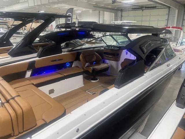 Slide: The Image of 2025 Chaparral 307 SSX boat interior with tan seating and modern design. - 16