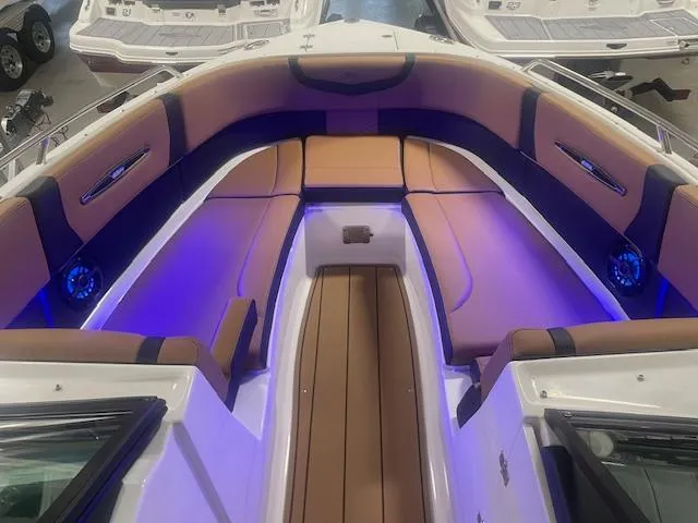 Slide: The Image of 2025 Chaparral 307 SSX boat interior with ambient blue lighting. - 18