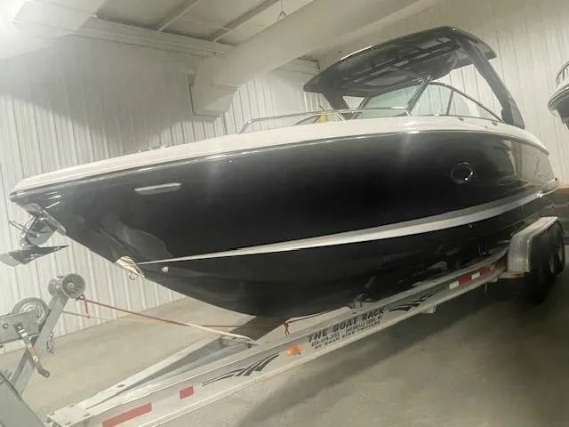Slide: The Image of 2025 Chaparral 307 SSX boat on trailer in indoor storage. - 2