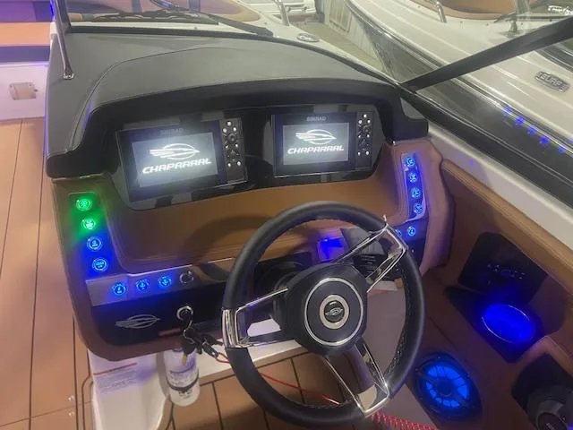 Slide: The Image of 2025 Chaparral 307 SSX boat dashboard with dual displays and illuminated controls. - 20