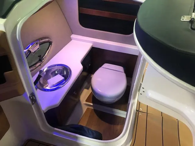 Slide: The Image of 2025 Chaparral 307 SSX boat interior with compact bathroom and modern amenities. - 21