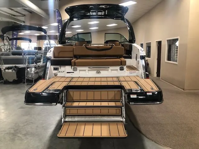 Slide: The Image of 2025 Chaparral 307 SSX boat with extended swim platform in showroom. - 4