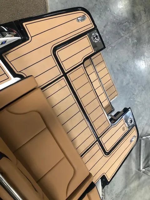 Slide: The Image of 2025 Chaparral 307 SSX boat interior with tan and black detailing. - 5