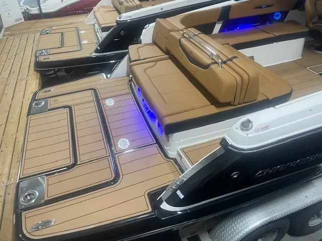 Slide: The Image of 2025 Chaparral 307 SSX boat with tan seating and blue LED lights. - 6