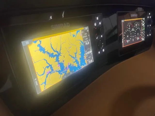 Slide: The Image of 2025 Chaparral 307 SSX dashboard with dual Simrad navigation displays. - 9