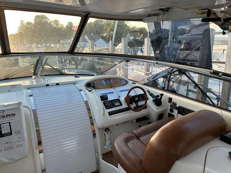 Slide: The Image of 1997 Sunseeker Camargue yacht cockpit with leather seating and navigation controls. - 2