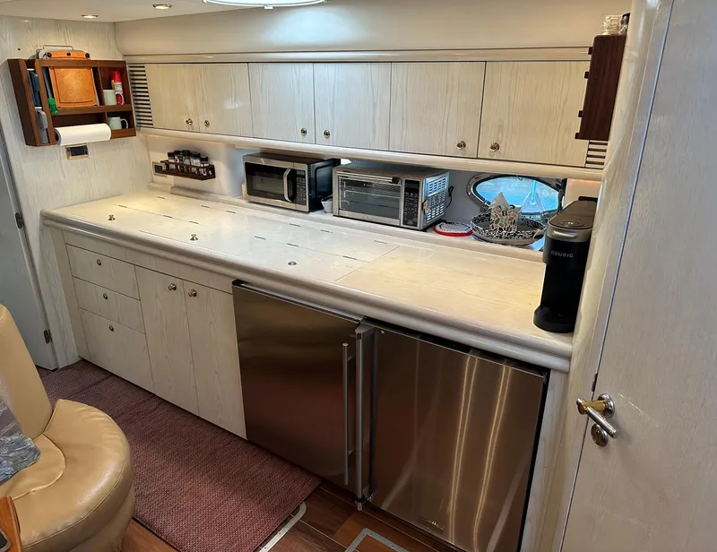 Slide: The Image of 1997 Sunseeker Camargue yacht kitchen with modern appliances and sleek cabinetry. - 4