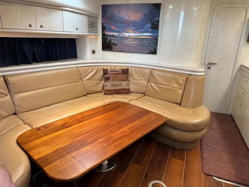 Slide: The Image of Luxurious interior of a 1997 Sunseeker Camargue yacht with leather seating and wooden table. - 5