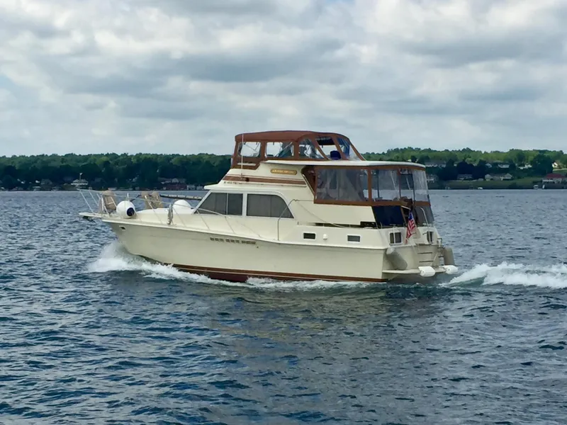 Slide: The Image of 1984 Uniflite Double Cabin cruising on a lake under cloudy skies. - 0
